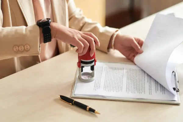 A notary stamp being applied to a time-sensitive document